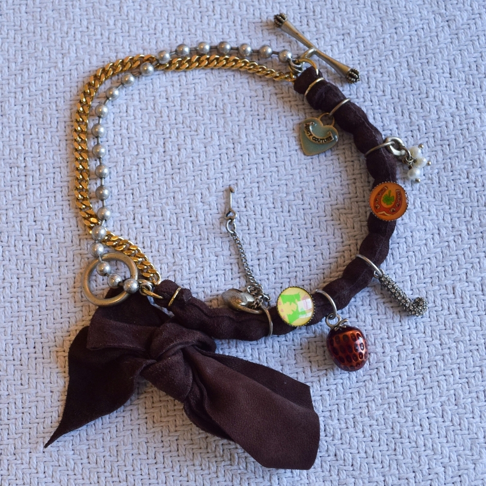 Juicy Couture vintage mixed lucky charm bracelet with a seude bow accent